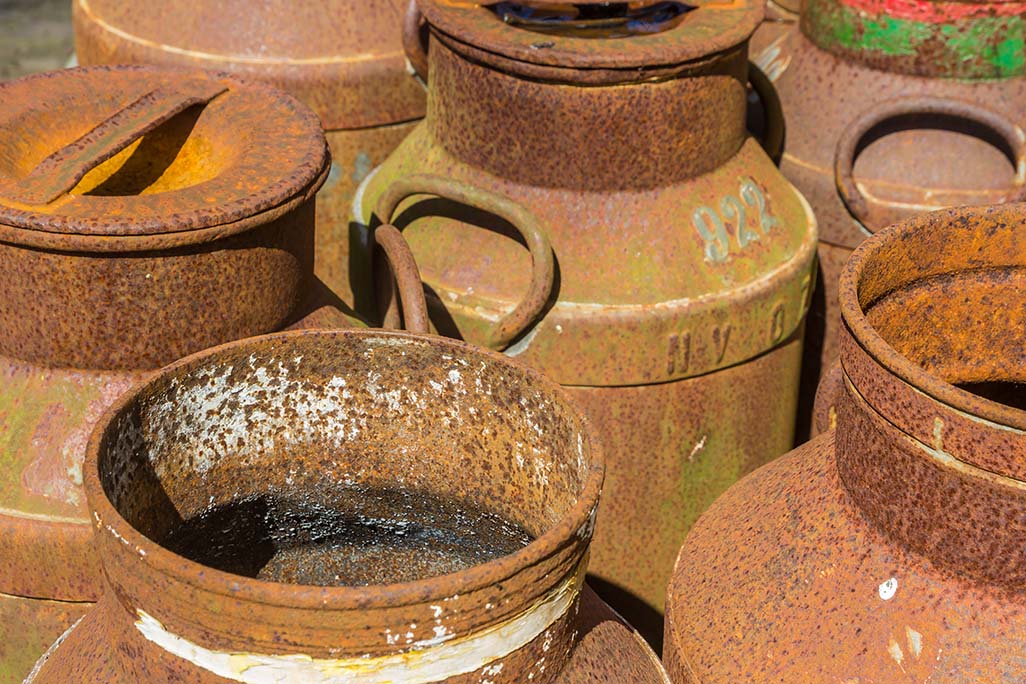 Old historic rusty milk canisters in Orvelte